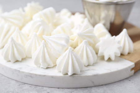 Delicious meringue cookies on gray table, closeup
