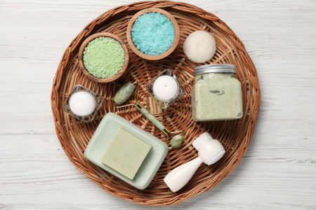 Composition with spa supplies and burning candles on white wooden table, top viewの写真素材