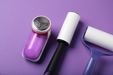 Lint rollers and fabric shaver on purple background, above viewの写真素材