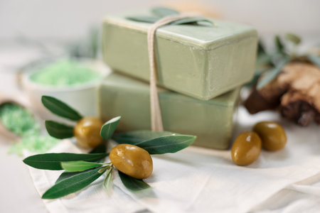 Natural soap bars and olives on white table, closeupの写真素材