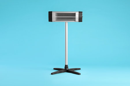 Electric infrared heater on light blue backgroundの写真素材
