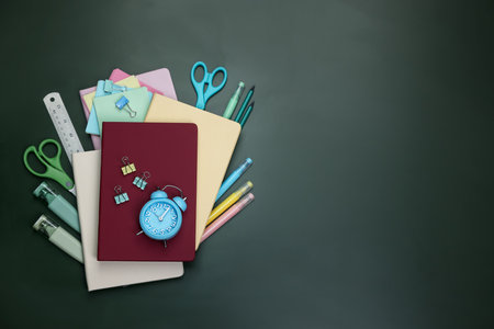 Happy teacher's day. Different stationery on green background, flat lay. Space for textの写真素材