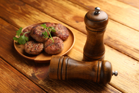 Salt and pepper shakers, meatballs on wooden table, closeupの写真素材
