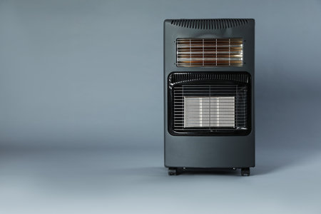 One electric heater on gray background. Space for textの写真素材