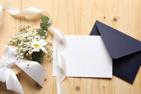 Blank card, envelope and decor on wooden table, flat layの写真素材