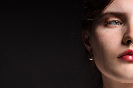 Sad woman crying on black background, closeupの写真素材