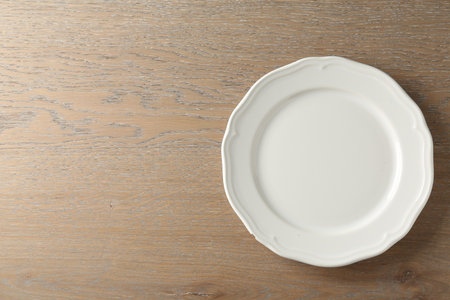 One stylish plate on wooden table, top view. Space for textの写真素材