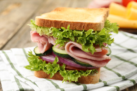 Tasty sandwich with ham and vegetables on table, closeupの写真素材