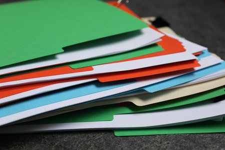 Many documents in folders on gray textured table, closeupの写真素材