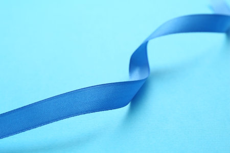 Beautiful ribbon on light blue background, closeupの写真素材