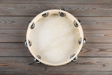 Tambourine on wooden background, top view. Traditional musical instrumentの写真素材
