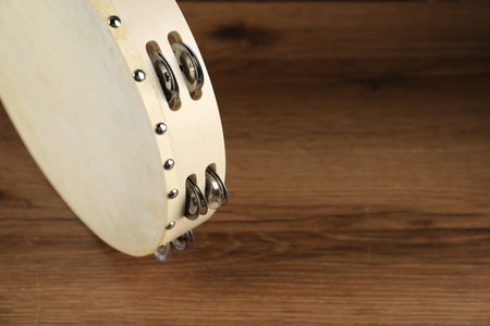 Tambourine on wooden background, closeup. Space for textの写真素材