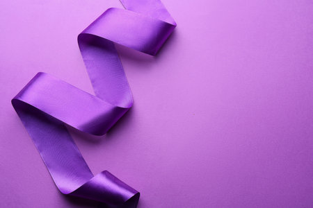 Beautiful ribbon on violet background, top view. Space for textの写真素材