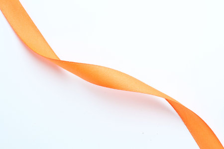 Beautiful orange ribbon on white background, top viewの写真素材