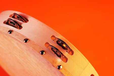 Tambourine on orange background, closeup.の写真素材