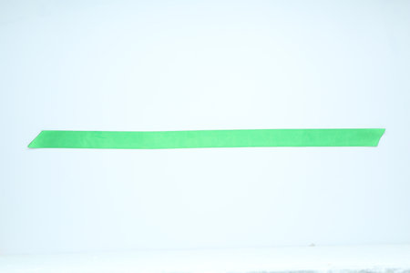 Beautiful light green ribbon on white background, top viewの写真素材