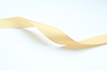 One beautiful yellow ribbon on white backgroundの写真素材