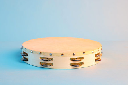 Tambourine on light blue background, space for textの写真素材