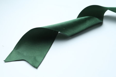 One beautiful green ribbon on white background, closeupの写真素材
