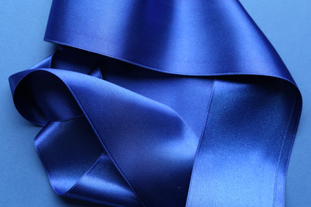 Beautiful blue ribbons on color background, top viewの写真素材