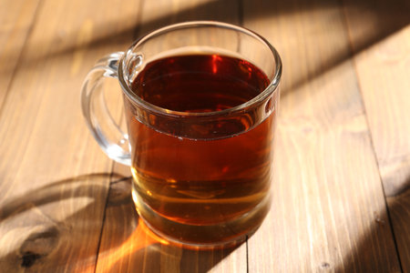 Aromatic black tea in cup on wooden table, closeupの写真素材