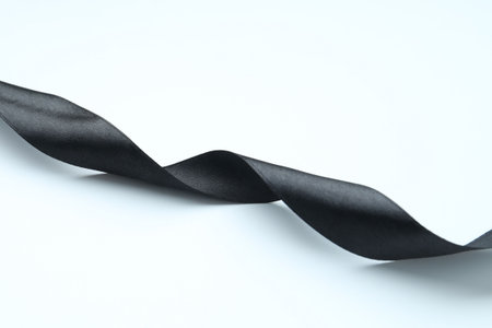 One beautiful black ribbon on white backgroundの写真素材