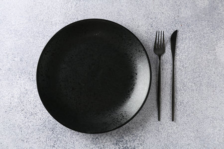 Stylish plate and cutlery on gray table, flat layの写真素材