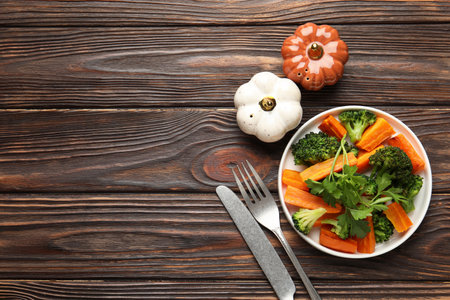 Vegetables, parsley and cutlery on wooden table, flat lay. Space for textの写真素材