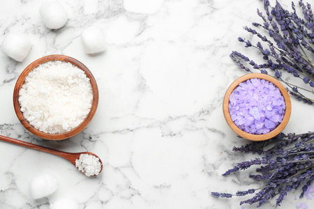 Sea salt and lavender on white marble table, flat lay. Space for textの写真素材