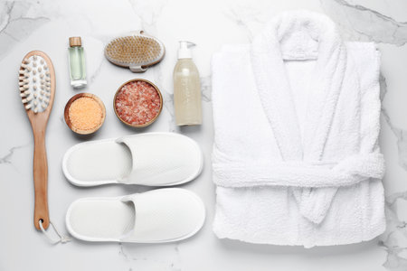 Flat lay composition with bathrobe and spa products on white marble backgroundの写真素材