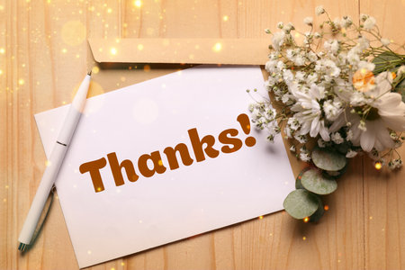 Thank you card, envelope, pen and flowers on wooden background, top view. Bokeh lightsの写真素材