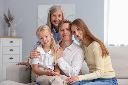 Senior woman with her son's family on sofa at home