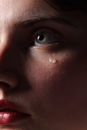 Closeup view of sad young woman crying