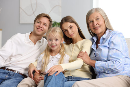 Senior woman with her son's family on sofa at home