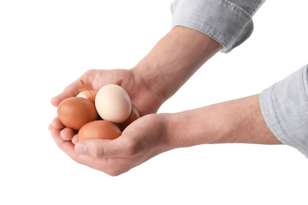 Person with raw chicken eggs on white background, closeupの写真素材
