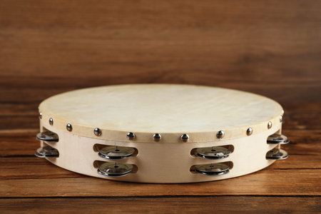 Tambourine on wooden background, closeup. Traditional musical instrumentの写真素材