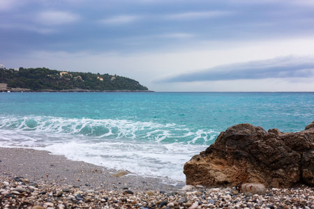 Beautiful view of wavy sea and rocks on beachの写真素材