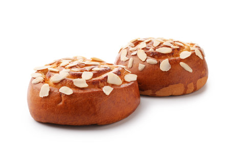 Tasty roll buns with almond flakes isolated on whiteの写真素材