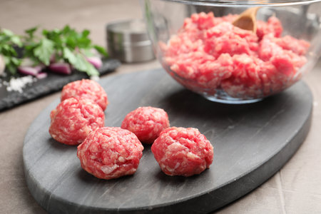 Raw meatballs and minced meat on gray table, closeupの写真素材