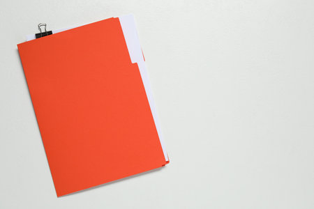 Documents in red folder on light gray background, top view. Space for textの写真素材