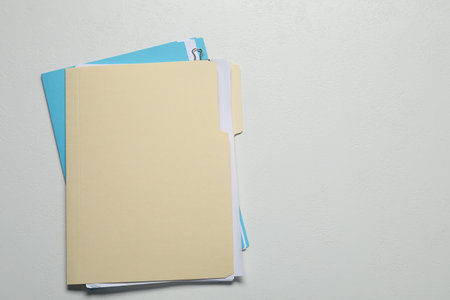 Many documents in folders on light gray background, top view. Space for textの写真素材