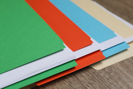 Many documents in folders on wooden table, closeupの写真素材
