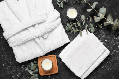 Flat lay composition with bathrobe and spa essentials on black backgroundの写真素材