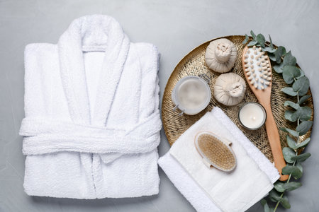 Flat lay composition with bathrobe and spa essentials on light gray backgroundの写真素材