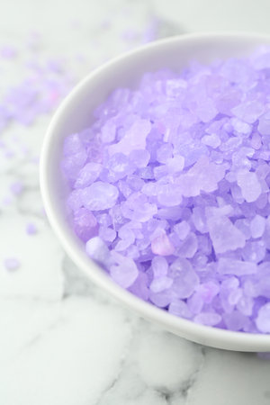 Violet sea salt in bowl on white marble table, closeupの写真素材
