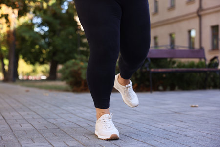 Woman in sneakers running outdoors, closeup. Healthy lifestyleの写真素材
