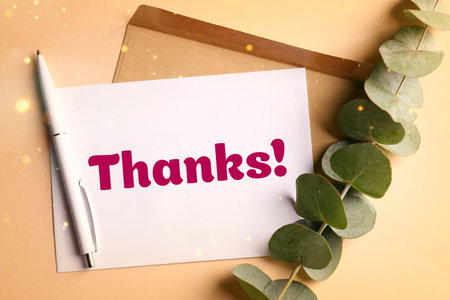 Thank you card, envelope, pen and eucalyptus branch on beige background, top view. Bokeh lightsの写真素材