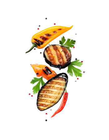 Grilled vegetables, parsley and peppercorns falling on white backgroundの写真素材
