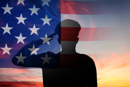 Silhouette of saluting policeman, flag of USA and sky, multiple exposureの写真素材