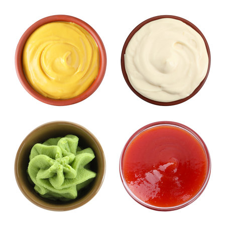Ketchup, mayonnaise, wasabi and mustard in bowls isolated on white, set. Top viewの写真素材